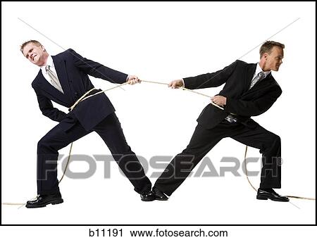 Stock Image - Business people engaged in a tug of war contest. Fotosearch