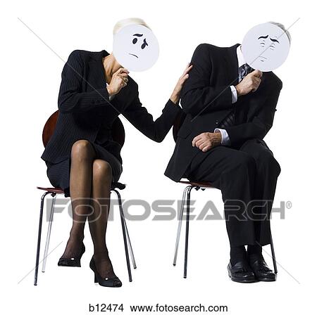Picture - Businessman and businesswoman holding expression masks. Fotosearch