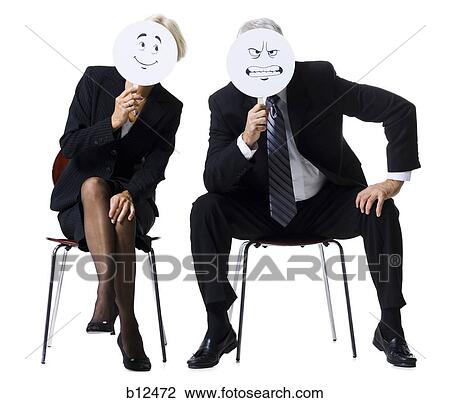 Businessman and businesswoman holding expression masks View Large Photo Image Stock Image - Businessman and businesswoman holding expression masks. Fotosearch