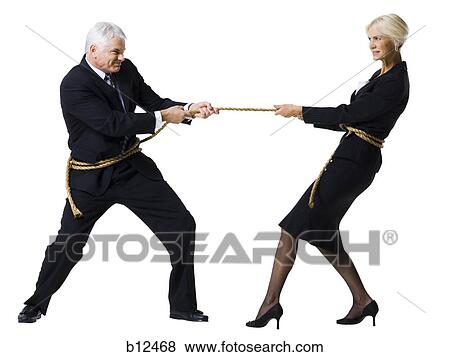 Businessman and businesswoman in a tug of war View Large Photo Image Stock Photo - Businessman and businesswoman in a tug of war. Fotosearch