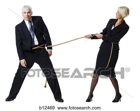Businessman and businesswoman in a tug of war View Large Photo Image Stock Photo - Businessman and businesswoman in a tug of war. Fotosearch