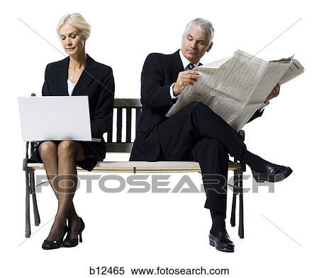 Businessman and businesswoman sitting on a bench View Large Photo Image Stock Photography - Businessman and businesswoman sitting on a bench. Fotosearch
