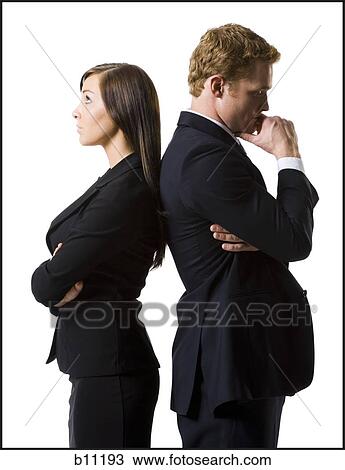 Businessman and businesswoman standing back to back View Large Photo Image Stock Image - Businessman and businesswoman standing back to back. Fotosearch