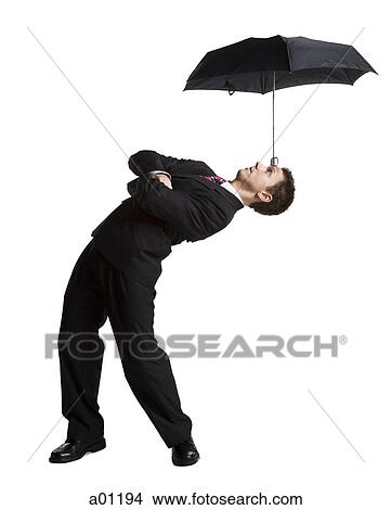 Businessman balancing umbrella on his forehead View Large Photo Image Picture - Businessman balancing umbrella on his forehead. Fotosearch