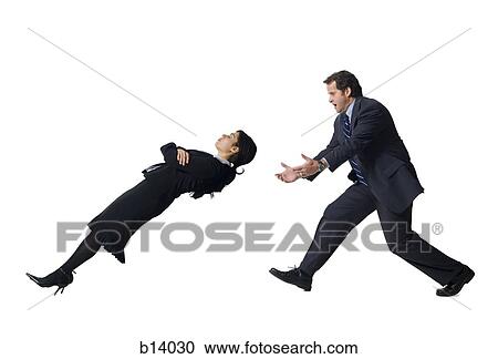 Stock Image - Businessman catching falling businesswoman. Fotosearch