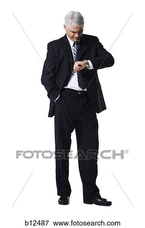 Businessman checking his watch View Large Photo Image Stock Photo - Businessman checking his watch. Fotosearch