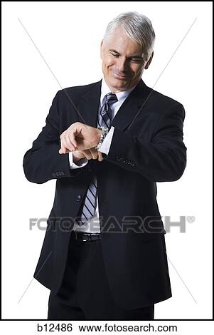 Businessman checking his watch View Large Photo Image Stock Photograph - Businessman checking his watch. Fotosearch
