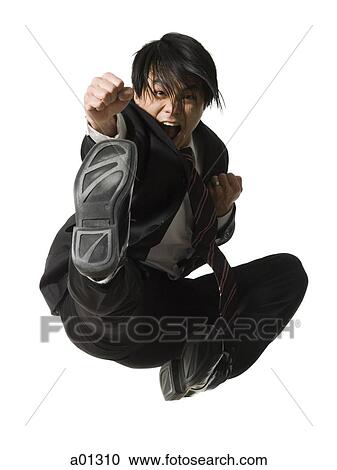 Businessman doing a karate kick View Large Photo Image Stock Image - Businessman doing a karate kick. Fotosearch