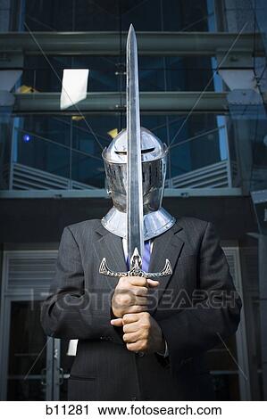 Businessman guarding with a medieval sword View Large Photo Image Stock Image - Businessman guarding with a medieval sword. Fotosearch