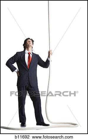 Businessman holding a rope View Large Photo Image Stock Image - Businessman holding a rope. Fotosearch