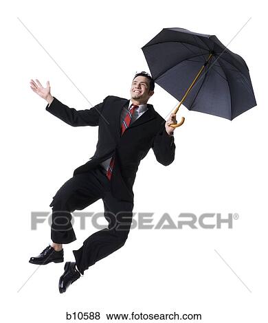 Stock Photo - Businessman holding an umbrella and jumping. Fotosearch