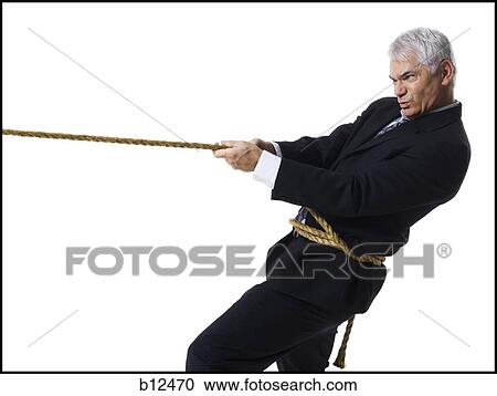 Businessman in a tug of war View Large Photo Image Stock Image - Businessman in a tug of war. Fotosearch