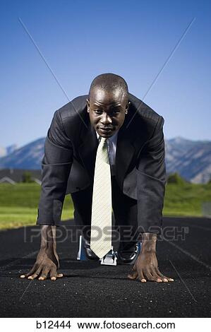 Picture - Businessman in starting position ready to race. Fotosearch