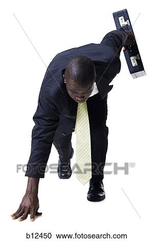 Businessman in starting position ready to race View Large Photo Image Stock Image - Businessman in starting position ready to race. Fotosearch