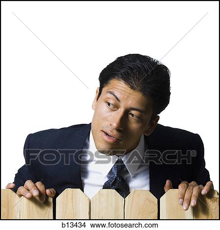 Businessman looking over wooden fence View Large Photo Image Picture - Businessman looking over wooden fence. Fotosearch