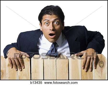 Businessman looking over wooden fence View Large Photo Image Stock Photography - Businessman looking over wooden fence. Fotosearch