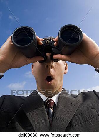 Businessman looking through binoculars outdoors View Large Photo Image Stock Image - Businessman looking through binoculars outdoors. Fotosearch