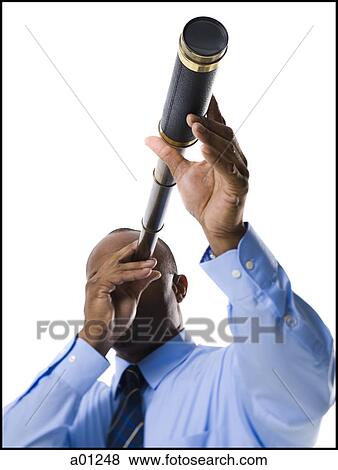 Businessman looking through telescope View Large Photo Image Stock Photo - Businessman looking through telescope. Fotosearch