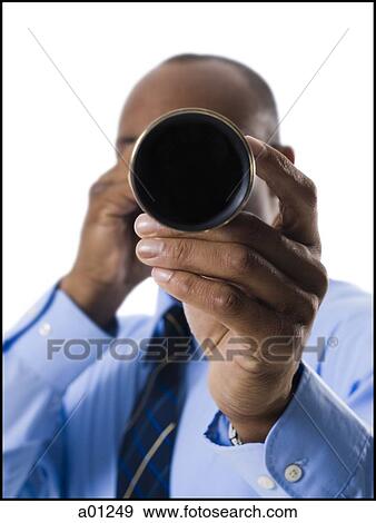 Businessman looking through telescope View Large Photo Image Stock Photo - Businessman looking through telescope. Fotosearch