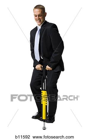 Businessman on a pogo stick View Large Photo Image Stock Image - Businessman on a pogo stick. Fotosearch