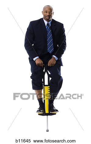 Businessman on a pogo stick View Large Photo Image Stock Photography - Businessman on a pogo stick. Fotosearch