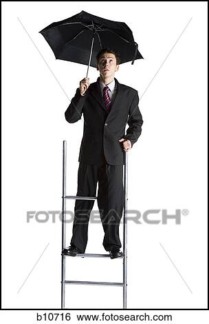 Businessman on corporate ladder holding umbrella View Large Photo Image Stock Photograph - Businessman on corporate ladder holding umbrella. Fotosearch