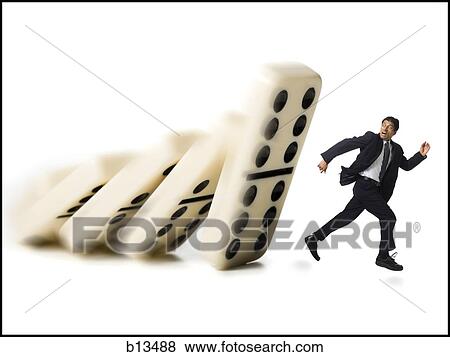 Businessman running from falling dominoes View Large Photo Image Stock Photo - Businessman running from falling dominoes. Fotosearch
