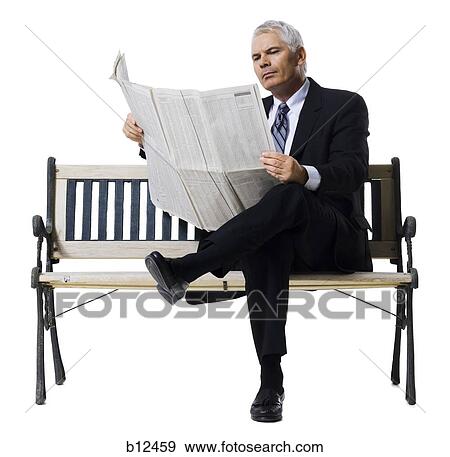 Stock Photo - Businessman sitting on bench reading newspaper. Fotosearch