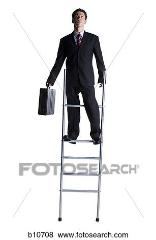Businessman standing on corporate ladder View Large Photo Image Stock Photo - Businessman standing on corporate ladder. Fotosearch