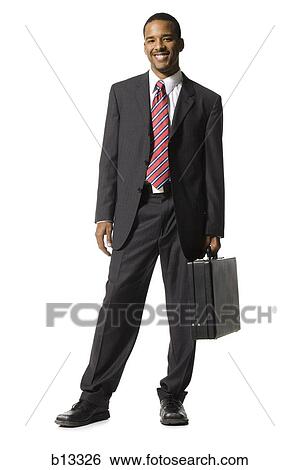 Stock Photograph - Businessman standing with briefcase. Fotosearch
