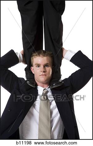 Stock Photo - Businessman supporting colleague on shoulders. Fotosearch