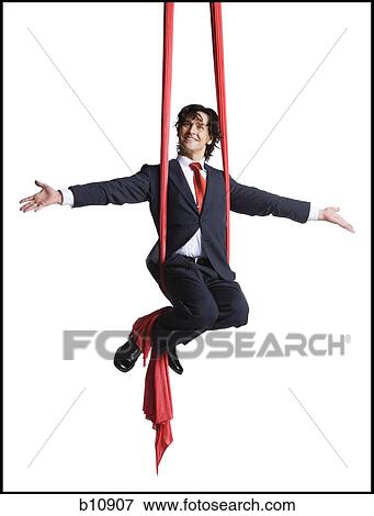 Stock Photo - Businessman tangled in red drapes. Fotosearch