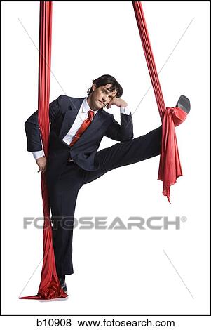 Businessman tangled in red drapes View Large Photo Image Stock Photo - Businessman tangled in red drapes. Fotosearch