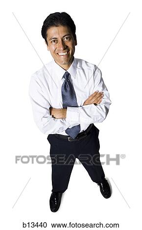 Businessman with arms crossed looking up smiling View Large Photo Image Stock Image - Businessman with arms crossed looking up smiling. Fotosearch