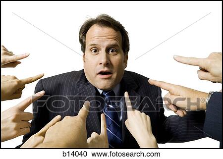 Stock Image - Businessman with fingers pointing at him. Fotosearch