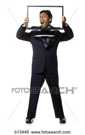 Businessman with funny face on monitor View Large Photo Image Stock Photo - Businessman with funny face on monitor. Fotosearch