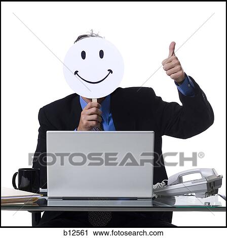 Businessman with happy face mask working on laptop View Large Photo Image Stock Image - Businessman with happy face mask working on laptop. Fotosearch