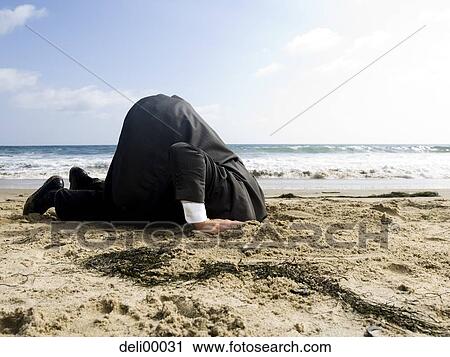 Businessman with head in sand View Large Photo Image Stock Image - Businessman with head in sand. Fotosearch