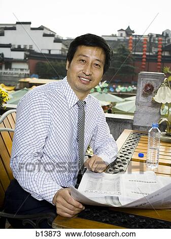 Businessman with newspaper outdoors View Large Photo Image Stock Image - Businessman with newspaper outdoors. Fotosearch