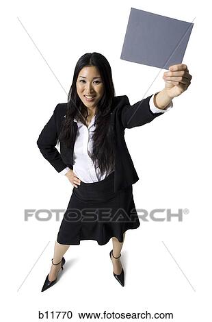 Stock Image - Businesswoman holding a blank sign. Fotosearch