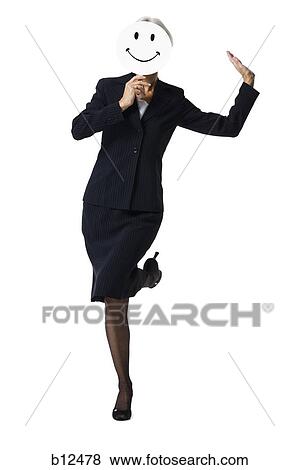 Businesswoman holding a happy face mask View Large Photo Image Stock Photo - Businesswoman holding a happy face mask. Fotosearch