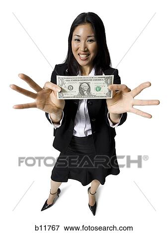 Stock Photo - Businesswoman holding a one dollar bill. Fotosearch