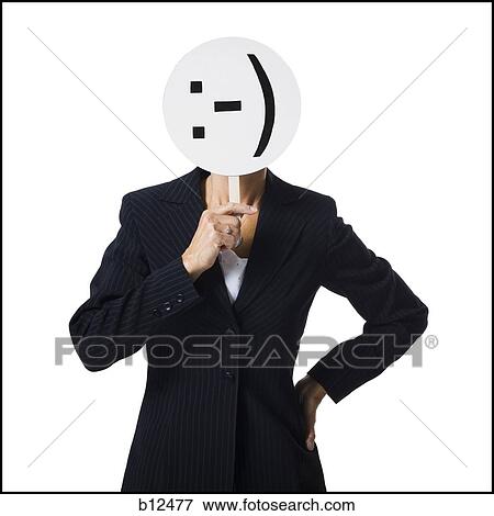 Stock Photo - Businesswoman holding a sideways happy face mask. Fotosearch