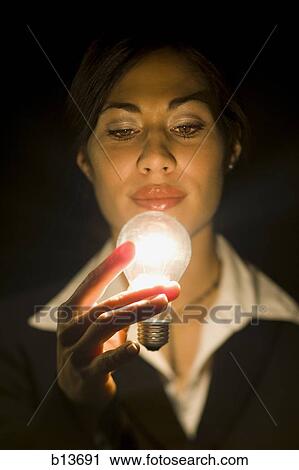 Businesswoman holding light bulb View Large Photo Image Stock Image - Businesswoman holding light bulb. Fotosearch