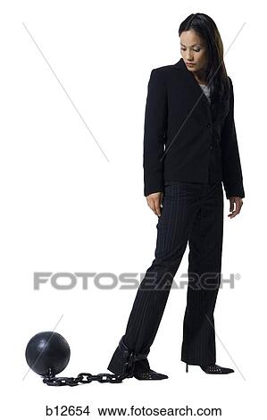 Businesswoman shackled to ball and chain View Large Photo Image Picture - Businesswoman shackled to ball and chain. Fotosearch