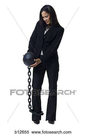 Businesswoman shackled to ball and chain View Large Photo Image Stock Photography - Businesswoman shackled to ball and chain. Fotosearch