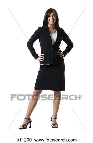 Stock Image - Businesswoman standing with hands on hips. Fotosearch