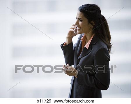 Stock Photo - Businesswoman talking on cell phone. Fotosearch