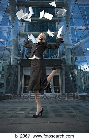 Businesswoman tossing papers in the air View Large Photo Image Stock Photo - Businesswoman tossing papers in the air. Fotosearch