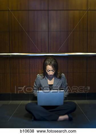 Businesswoman using a laptop View Large Photo Image Stock Photo - Businesswoman using a laptop. Fotosearch